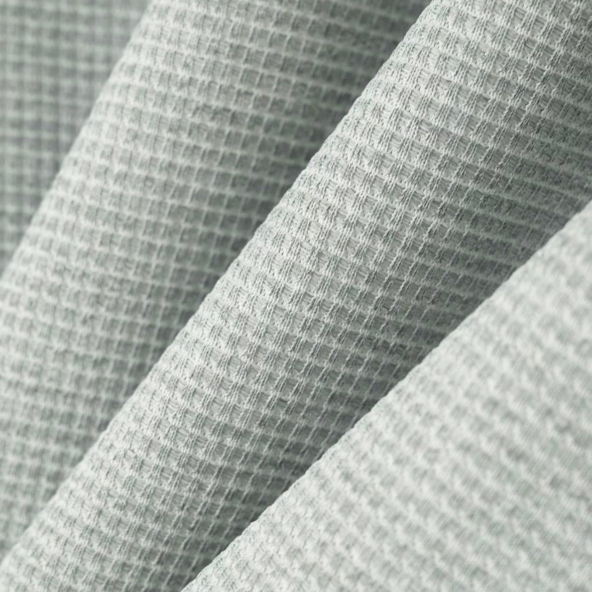 Close-up of textured gray fabric with a subtle pattern